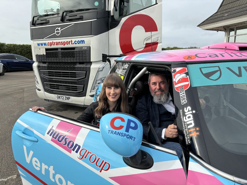 Lydia sitting in her Mini with Adam Searle from CP Transport
